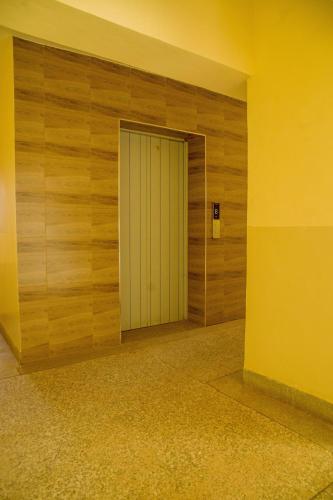a door in a room with a wooden wall at Saki Nest Homes2 in Kisumu