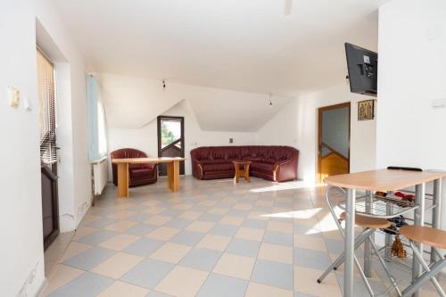 a living room with a couch and a table at Colina Mărului 