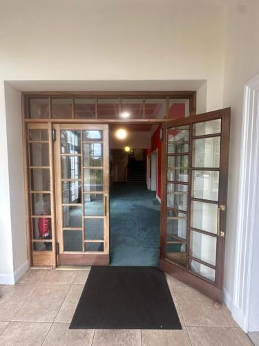 an open door of a room with a hallway at Cluny Hill Hotel in Forres