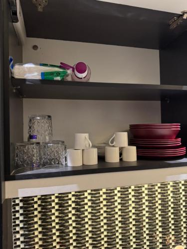 a shelf with plates and dishes on it in a kitchen at 2 bedrooms with attached baths in Karachi
