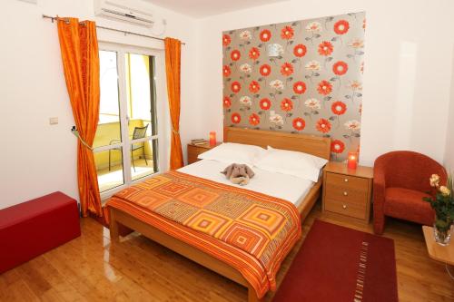 a dog laying on a bed in a bedroom at Sunrise Apartments in Cavtat