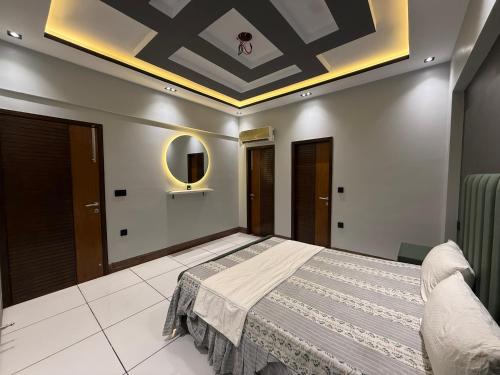 a bedroom with a large bed with a ceiling at 2 bedrooms with attached baths in Karachi