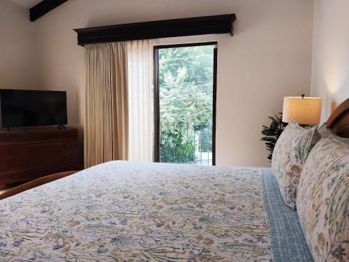 a bedroom with a bed and a large window at Casa Luz de Luna - Comfortable 3 Br, 3,5 Bath house in Potrero