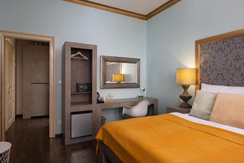 a hotel room with a bed and a desk at Salvatore Prague Rooms in Prague