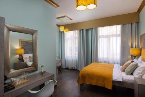 a hotel room with a bed and a mirror at Salvatore Prague Rooms in Prague