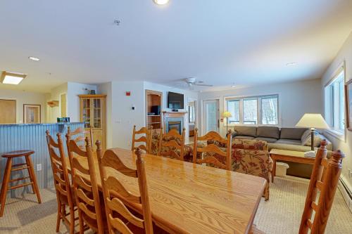 a dining room and living room with a table and chairs at Trailside Highlands 19B in Jeffersonville