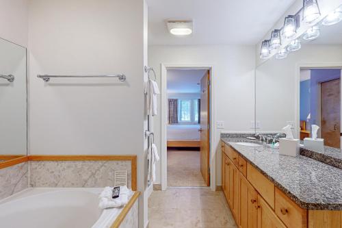 a bathroom with a tub and a large mirror at Trailside Highlands 19B in Jeffersonville