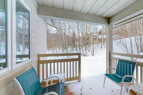 a porch with two chairs and a snow covered yard at Trailside Highlands 19B in Jeffersonville