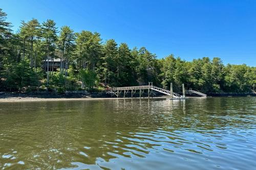 a dock in the middle of a body of water at Birch Grove Cabin in Fort Edgecomb