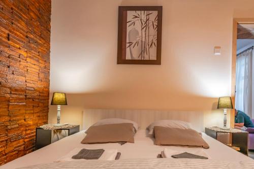 a bedroom with a bed with two pillows on it at Ultracentral Apartment 2 in Braşov