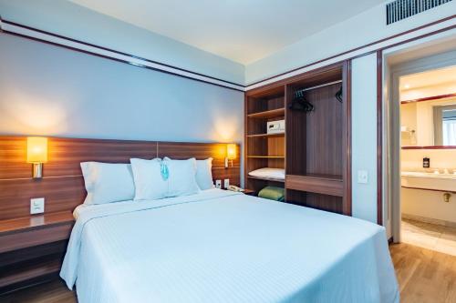 a bedroom with a large bed and a bathroom at Bristol The Time Berrini in Sao Paulo