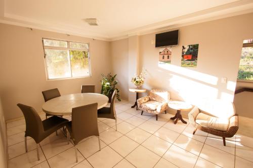 a dining room with a table and chairs at CHA Mime Hotel in Blumenau