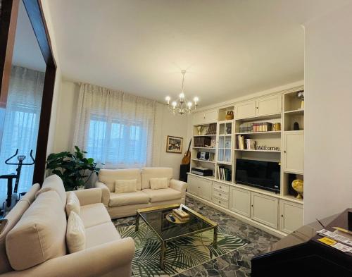 a living room with white furniture and a chandelier at Luxury Relax Apartment near Venice Station in Venice