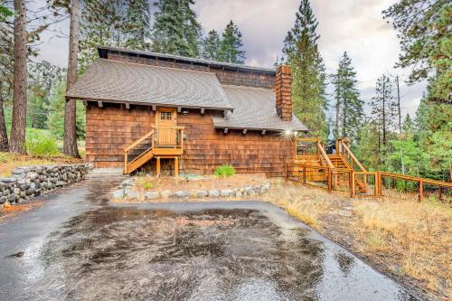 a log cabin with a pond in front of it at Peaceful Getaway Pet Friendly with Hot Tub and Grill in Tahoe City