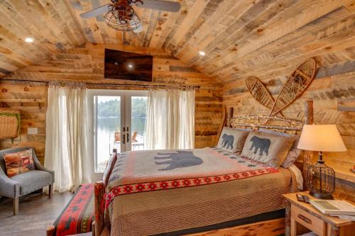 a bedroom with a bed in a log cabin at Cozy Cabin on Crooked Lake Hike, Ski and Explore! in Averill Park