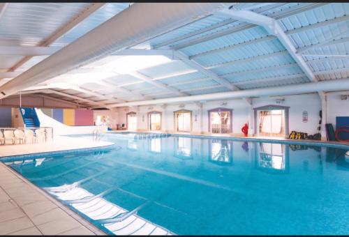 a large swimming pool in a building at 6 dunster court haven park doniford bay in Watchet