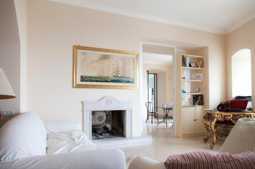 a living room with a fireplace and a table at La Dolce Vista - B&B di Charme in Manfredonia