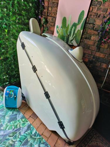 a white boat is sitting on the ground at Hidden Gem RUWARI in Cape Town