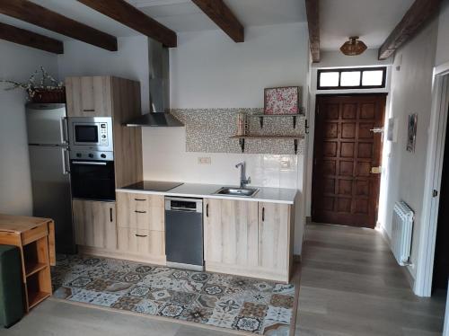 a kitchen with a sink and a stove at Cesarina Urban Rural House in Chantada