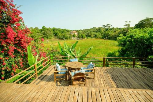 a wooden deck with a table and chairs on it at Recanto do villa 2 in Trancoso