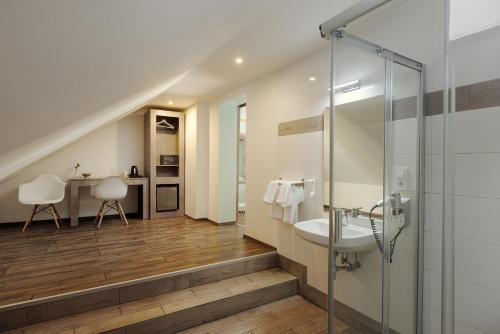 a bathroom with a sink and a shower at Salvatore Prague Rooms in Prague