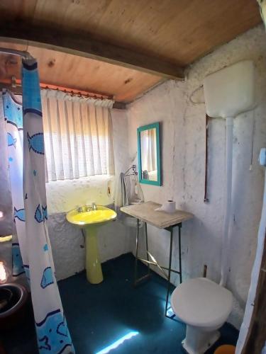 a small bathroom with a sink and a toilet at El Rancho de Marcela in Cabo Polonio
