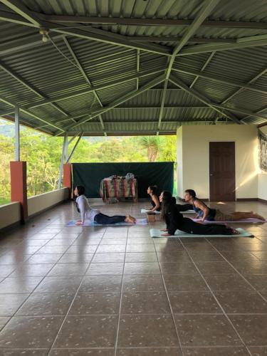 a group of people laying on the floor in a room at Casa Livity in Turrialba