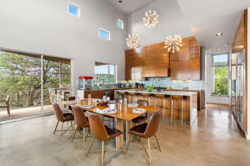 a dining room with a table and chairs in a kitchen at Luxury 7BR Hill Country Gem Hot Tub & Barndominium in Dripping Springs
