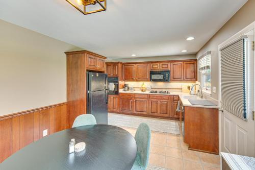 a kitchen with a table and a black refrigerator at Near Dtwn Harrisburg Stylish Home with Patio and Yard in Camp Hill