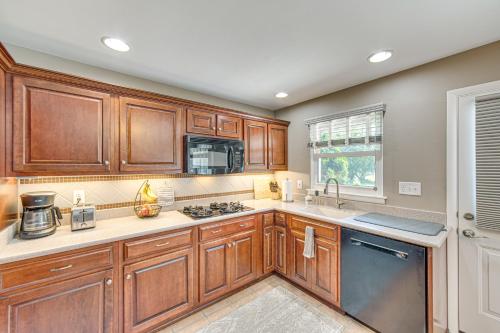 a kitchen with wooden cabinets and a sink at Near Dtwn Harrisburg Stylish Home with Patio and Yard in Camp Hill