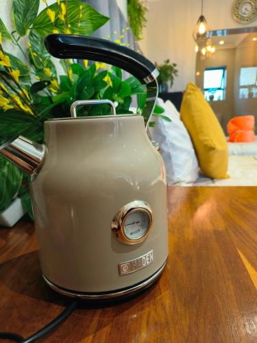 a toaster sitting on top of a wooden table at Hidden Gem RUWARI in Cape Town