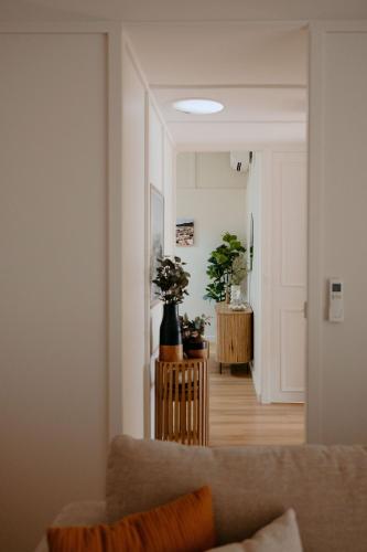 a living room with a couch and a hallway at Casa Agonis in Geographe