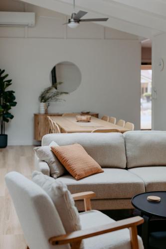 a living room with two couches and a table at Casa Agonis in Geographe