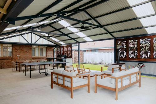 a large room with tables and ping pong tables at Casa Agonis in Geographe