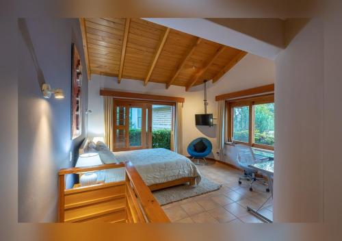 a bedroom with a bed and a desk in a room at Love Nest Atitlán in Panajachel