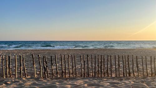 a beach with a fence in the sand at Regina Margherita Luxury House in Modica