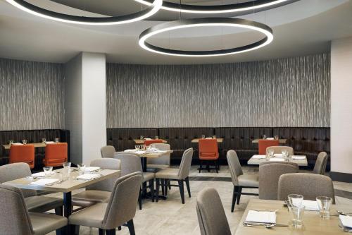 a dining room with tables and chairs and a ceiling at Chicago Marriott Oak Brook in Oak Brook
