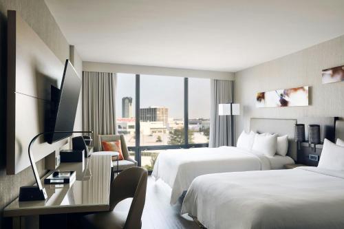 a hotel room with two beds and a window at Chicago Marriott Oak Brook in Oak Brook