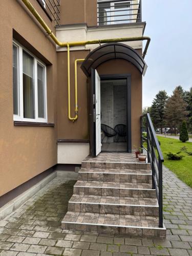 a stairway leading to a door of a house at Апартаменти новобудова Львів in Lviv