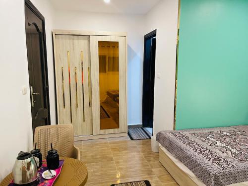 a bedroom with a bed and a table and a chair at Farida Pyramids ŌTEL in Cairo