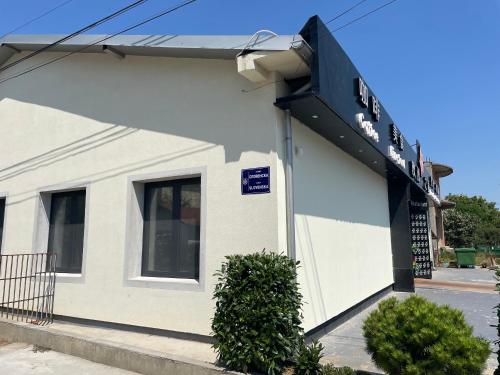 a white building with a sign on it at 5min Airport in Surčin