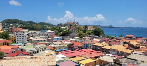 an overview of a city with buildings and the ocean at Oceanview Suites in Saint Georgeʼs