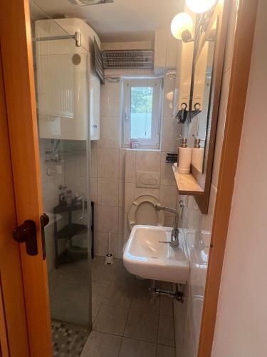 a small bathroom with a sink and a mirror at Central Home in Salzburg
