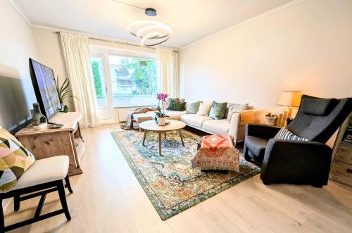 a living room with a couch and a table at Comfy room - Ski center - near Ås - 11 min to Oslo in Ski