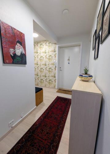 a living room with a hallway with a painting on the wall at Comfy room - Ski center - near Ås - 11 min to Oslo in Ski