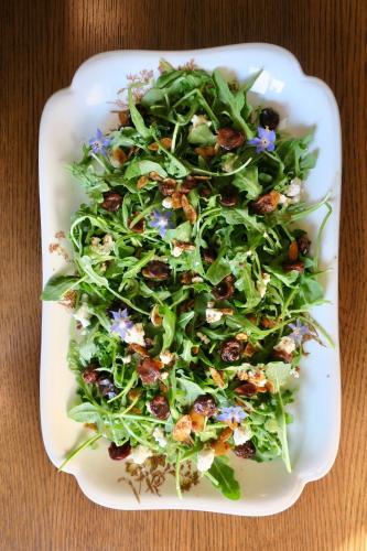 a salad on a white plate on a table at The Indigo House, an adults only, modern bed and breakfast for outdoorsy humans and kind dogs in Afton