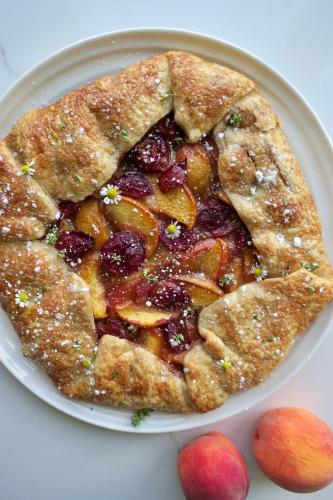 a plate with a pie with fruit on it at The Indigo House, an adults only, modern bed and breakfast for outdoorsy humans and kind dogs in Afton