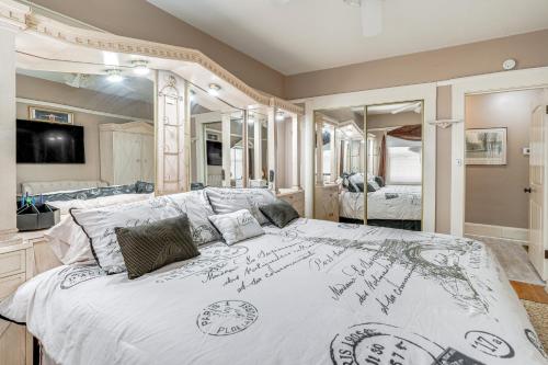 a bedroom with a large bed with a large mirror at Miracle Mile Stay Classic Stockton Home with Yard! in Stockton