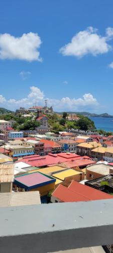 a view of a city with colorful roofs at Oceanview Suites in Saint Georgeʼs