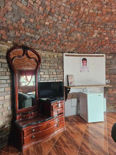 a wooden dresser with a mirror on top of it at Le Ville Guatamonaco in Guatavita